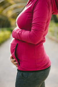 Detail of pregnant sporty woman belly